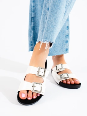 White slip-on sandals with decorative buckles